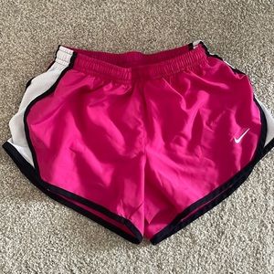 Girls Nike running shorts. Pink with black trim.
